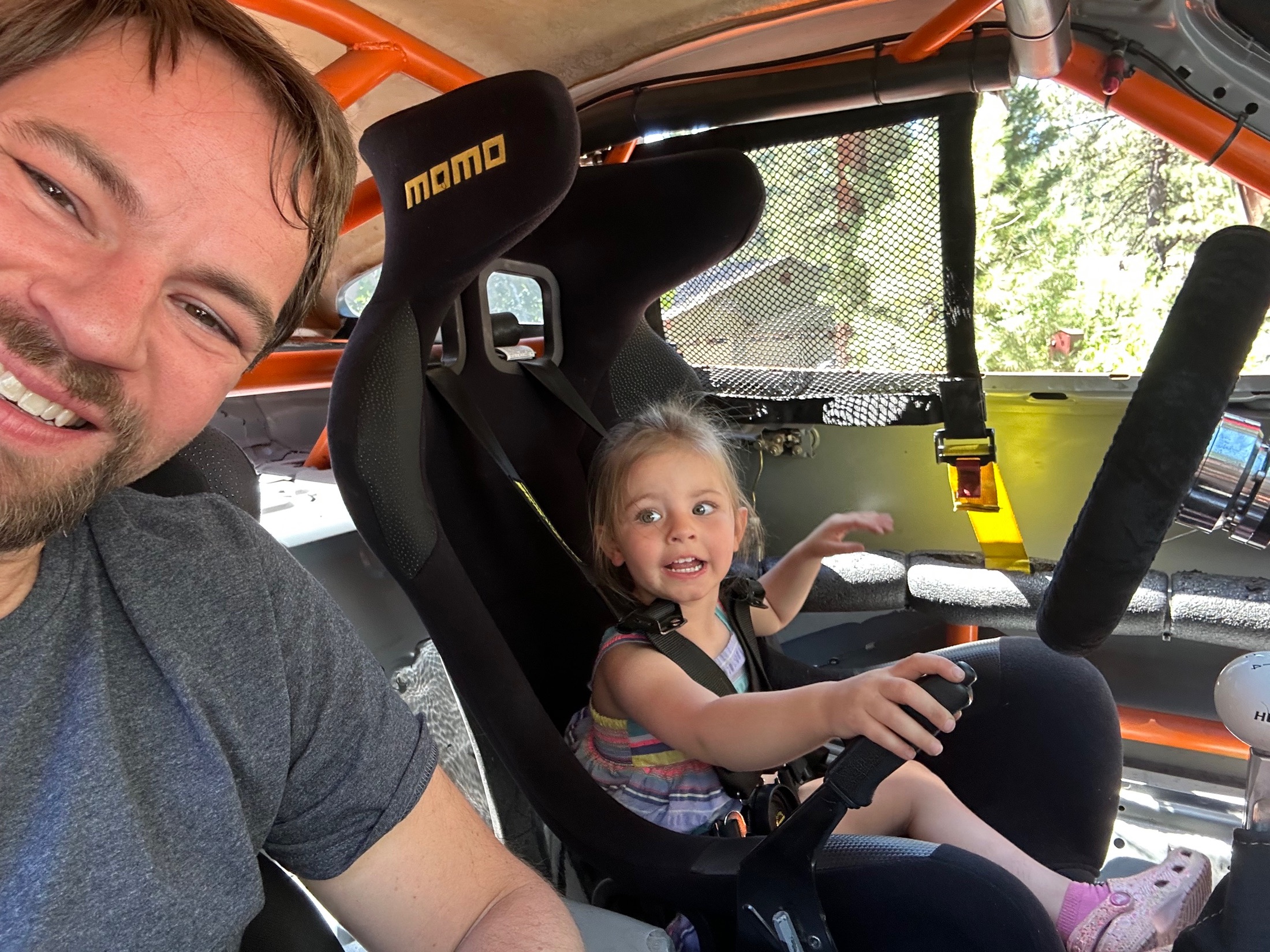 Nick Buchanan and his daughter sitting in the race car